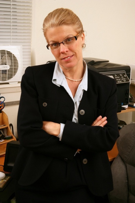 Mature blonde secretary Lauren E exposes her big ass and twat in stockings
