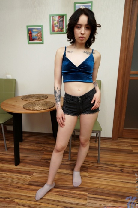 Petite babe Korolina Geiman strips fully naked & spreads her yummy pussy